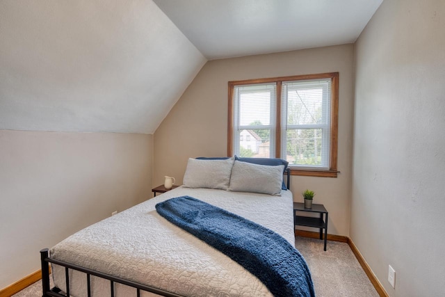 bedroom with carpet and lofted ceiling