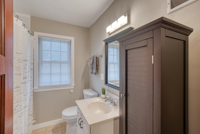 bathroom featuring tile patterned floors, vanity, and toilet