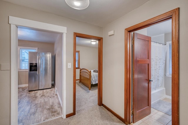 hall with light hardwood / wood-style floors