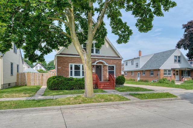 bungalow-style home with a front yard