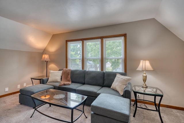 carpeted living room featuring lofted ceiling