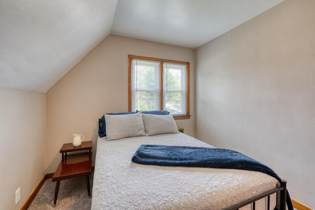 carpeted bedroom featuring lofted ceiling