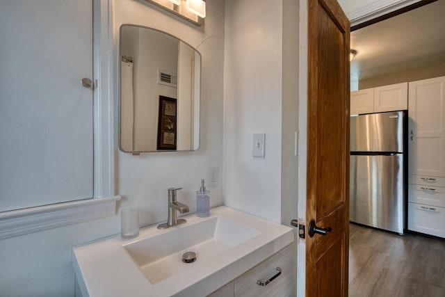 bathroom featuring hardwood / wood-style floors and vanity