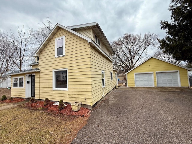 414 8th St, Baraboo, WI 53913 - view of property exterior featuring a detached garage and an outdoor structure