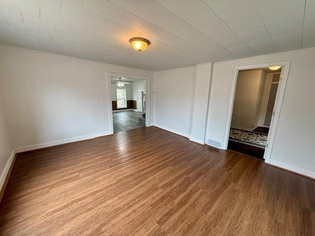 414 8th St, Baraboo, WI 53913 - spare room featuring baseboards, a ceiling fan, wood finished floors, and visible vents