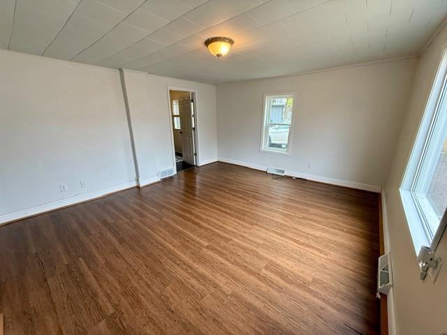 414 8th St, Baraboo, WI 53913 - spare room with baseboards, visible vents, and wood finished floors