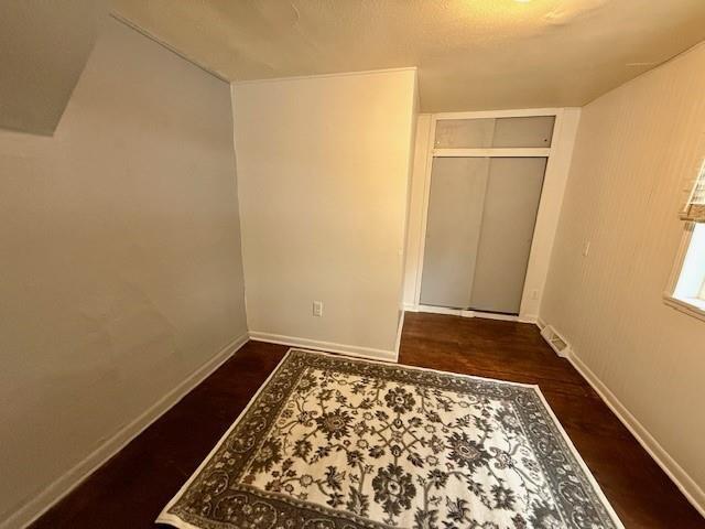 414 8th St, Baraboo, WI 53913 - unfurnished bedroom with baseboards, wood finished floors, and a closet