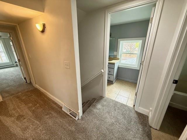 414 8th St, Baraboo, WI 53913 - hall with baseboards, visible vents, carpet, and an upstairs landing