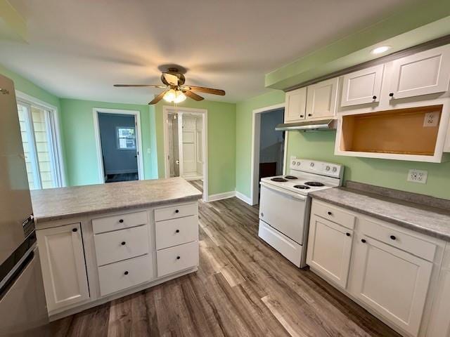 414 8th St, Baraboo, WI 53913 - kitchen with white cabinets, light countertops, a ceiling fan, and white electric range