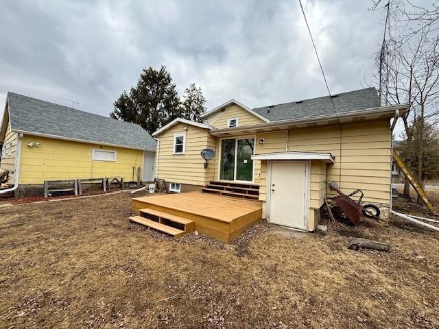 414 8th St, Baraboo, WI 53913 - rear view of house featuring fence, a shingled roof, and a deck
