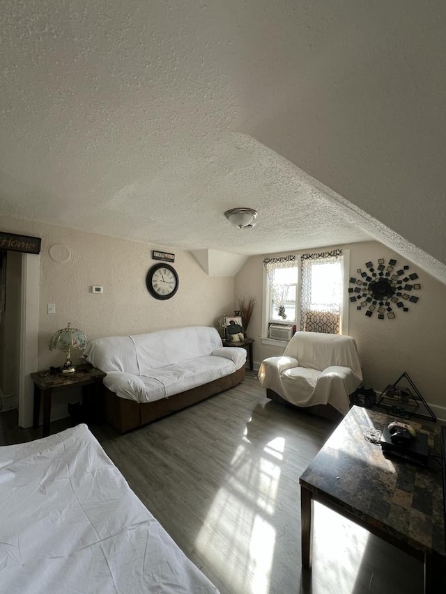 unfurnished bedroom featuring a textured ceiling and hardwood / wood-style floors