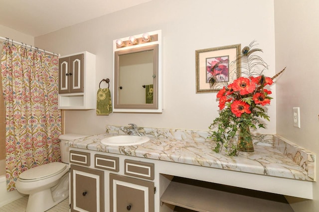 bathroom featuring tile patterned floors, vanity, and toilet