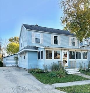 view of front of property featuring an outbuilding and a garage