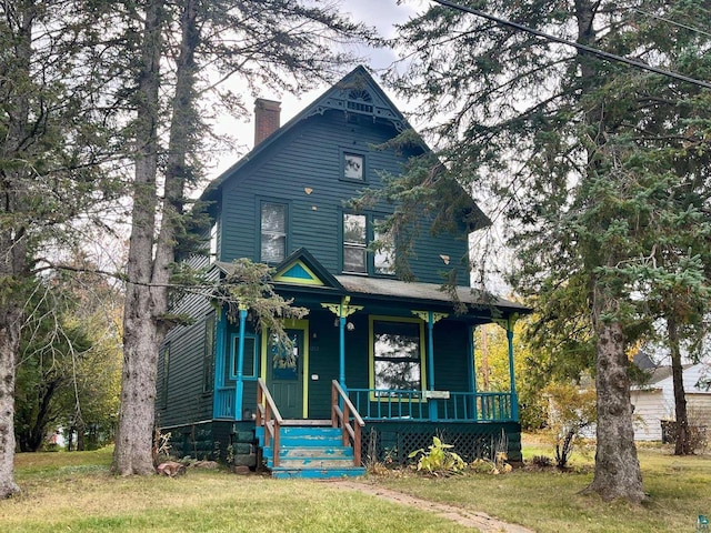 victorian house with a porch and a front yard