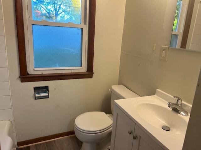 bathroom featuring vanity, hardwood / wood-style floors, toilet, and plenty of natural light