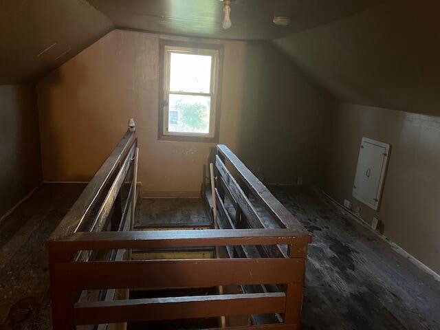 interior space with hardwood / wood-style flooring and vaulted ceiling