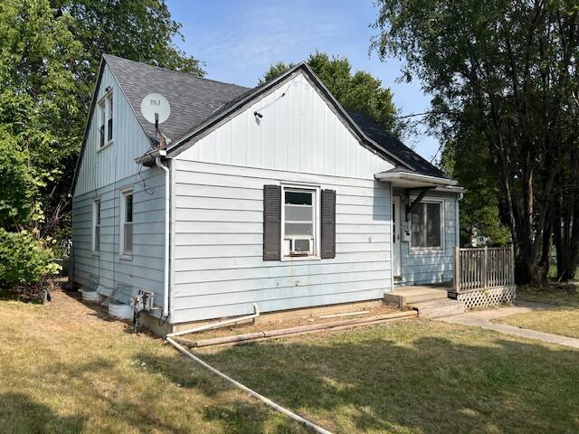 view of side of property with a yard