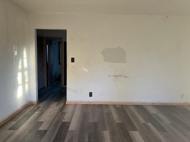 spare room featuring dark hardwood / wood-style floors