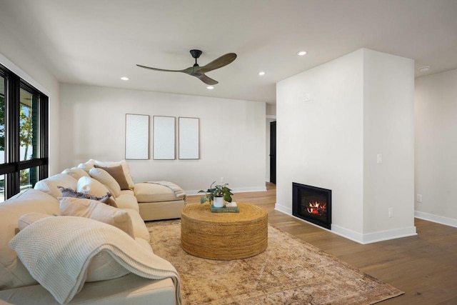 2291 Williams Point Dr, Stoughton, WI 53589 - living room featuring recessed lighting, wood finished floors, a ceiling fan, baseboards, and a lit fireplace