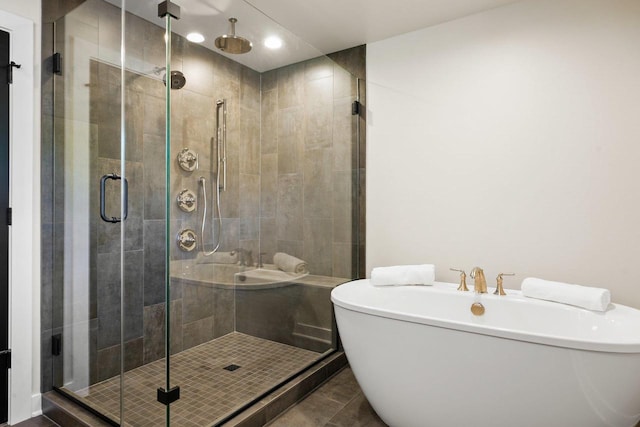 bathroom featuring tile patterned floors and shower with separate bathtub