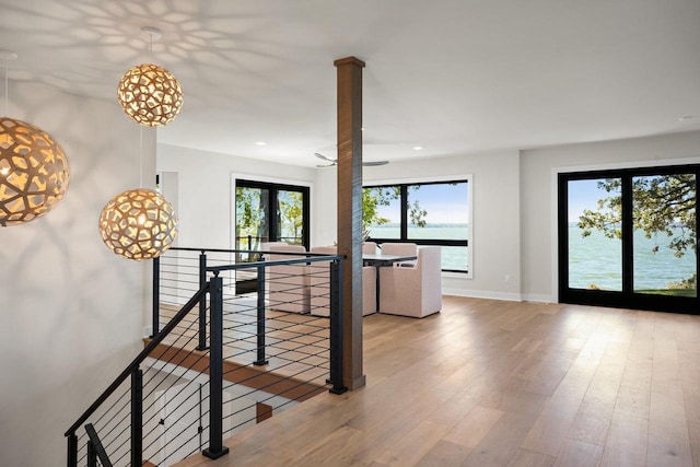 interior space featuring a water view and wood-type flooring