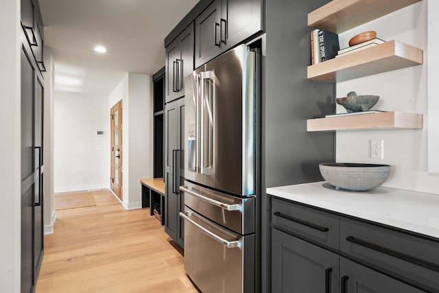 2291 Williams Point Dr, Stoughton, WI 53589 - kitchen featuring stainless steel fridge, open shelves, light wood-style floors, light countertops, and baseboards
