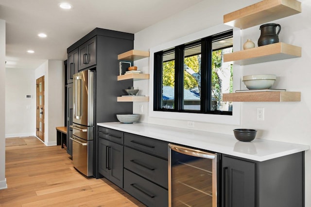 2291 Williams Point Dr, Stoughton, WI 53589 - kitchen with open shelves, beverage cooler, high end fridge, light wood-style floors, and recessed lighting