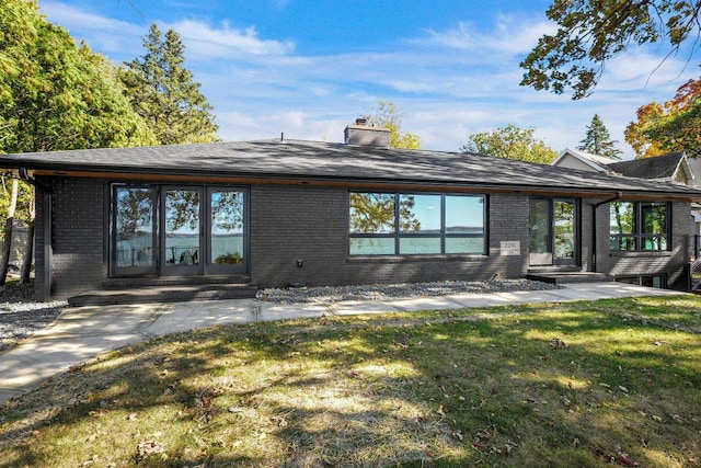 rear view of house with a lawn