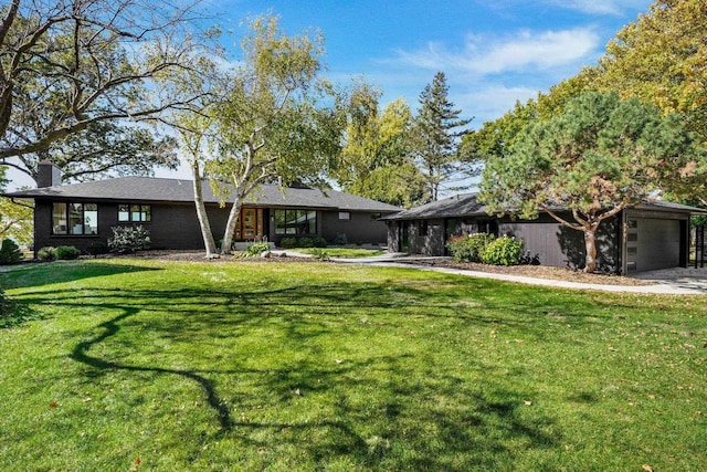 single story home with a front yard and a garage