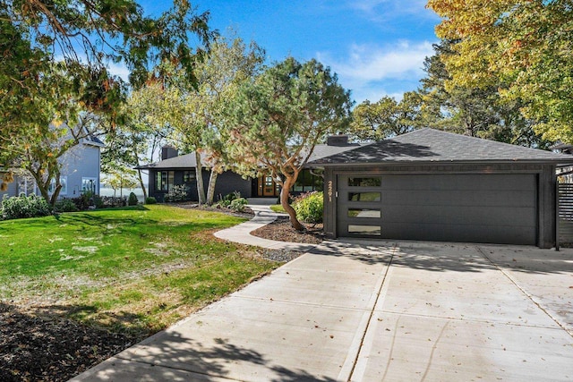 2291 Williams Point Dr, Stoughton, WI 53589 - view of front of home with driveway, a front lawn, an attached garage, and a chimney