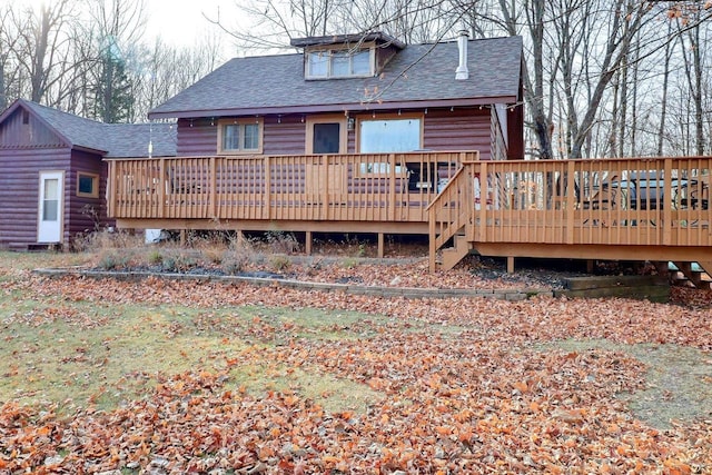 back of property featuring a deck