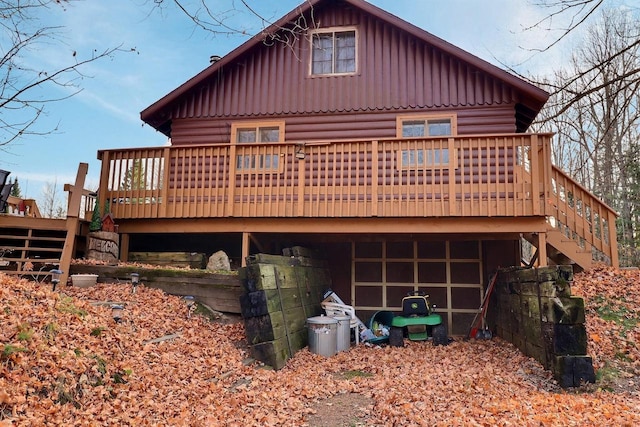 rear view of property featuring a wooden deck