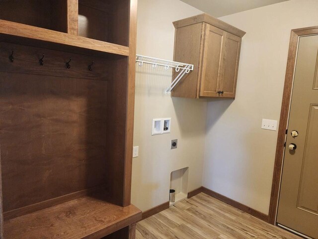 clothes washing area with hookup for a washing machine, baseboards, hookup for an electric dryer, cabinet space, and light wood-type flooring