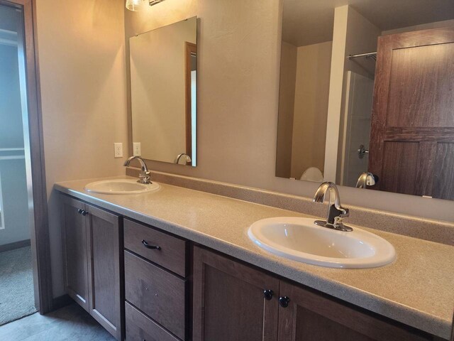 full bathroom featuring a sink and double vanity