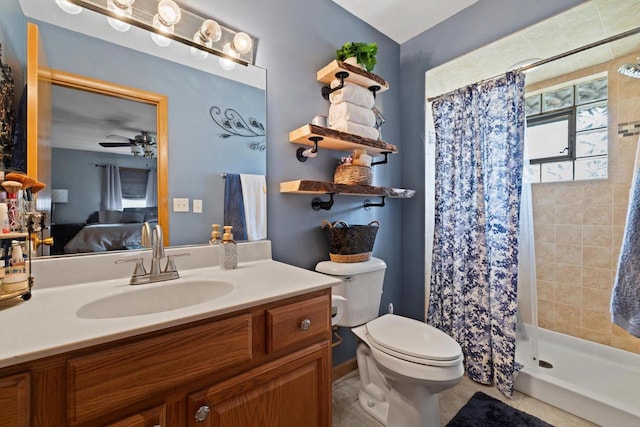 bathroom featuring toilet, ceiling fan, walk in shower, vanity, and tile patterned flooring