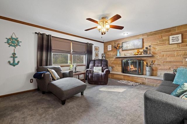 living room with ornamental molding, carpet floors, a fireplace, and ceiling fan