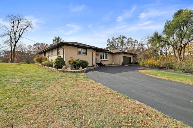 single story home featuring a garage and a front lawn