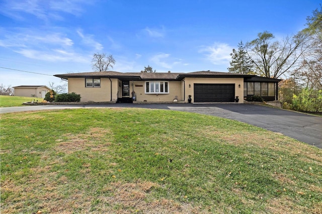 single story home with a garage and a front lawn