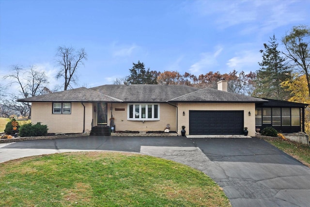 view of front facade featuring a garage and a front lawn