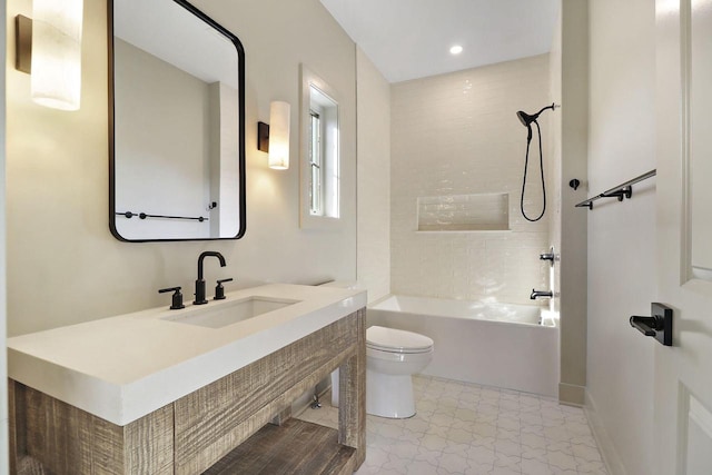 full bathroom featuring toilet, tiled shower / bath combo, and vanity