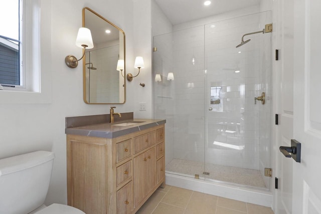 bathroom with vanity, toilet, a shower with shower door, and tile patterned flooring