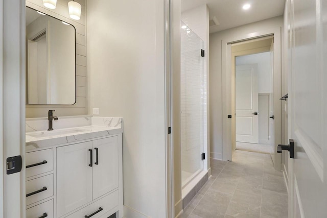 bathroom with vanity, a shower with shower door, and tile patterned floors