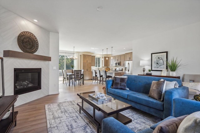 living room with an inviting chandelier and hardwood / wood-style floors