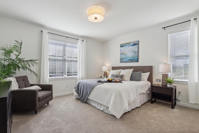 carpeted bedroom with multiple windows