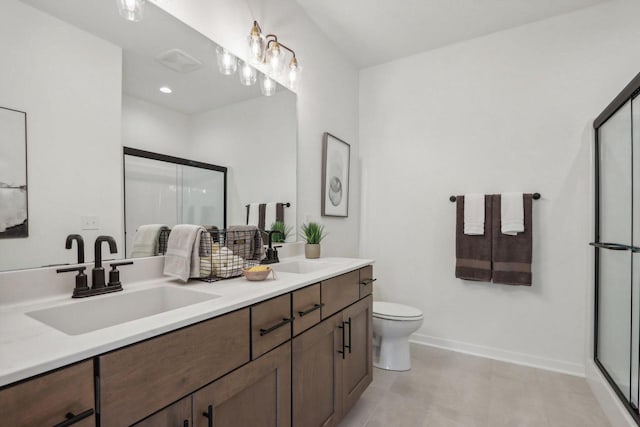 bathroom featuring vanity, a shower with shower door, and toilet