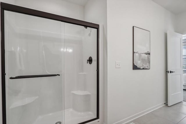 bathroom featuring walk in shower and tile patterned flooring