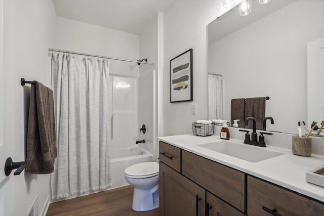 full bathroom with vanity, hardwood / wood-style floors, shower / bath combo with shower curtain, and toilet