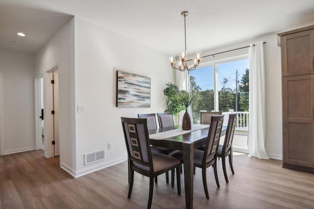 dining room with a notable chandelier and hardwood / wood-style flooring