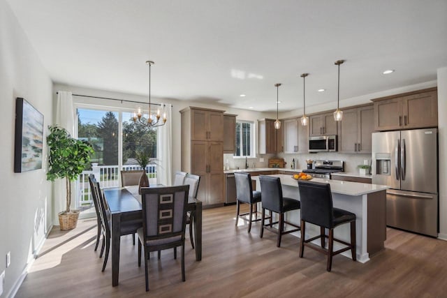 dining space featuring a chandelier and dark wood-type flooring