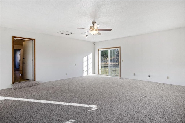 carpeted spare room with a textured ceiling and ceiling fan